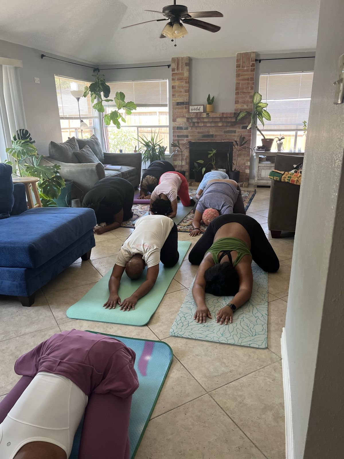 A room of Black women resting in child's pose on yoga mats at We Rest as Reparations Chapter Two