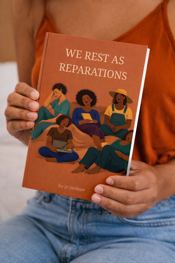 Woman holding the We Rest as Reparations journal by JC Jackson